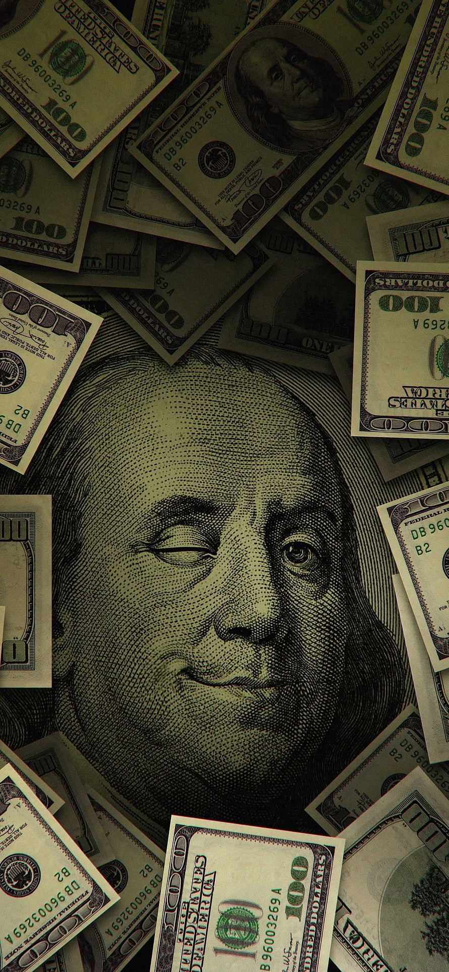 Close-up of Benjamin Franklin's face on a hundred dollar bill surrounded by scattered US currency HD phone wallpaper