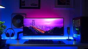 Modern Gaming Desk Setup With Ultrawide Monitor, RGB Lighting, And City Bridge Wallpaper HD wallpaper