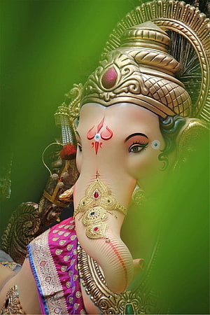 Close-up of Lord Ganesha Statue with Golden Crown and Jewelry HD phone wallpaper