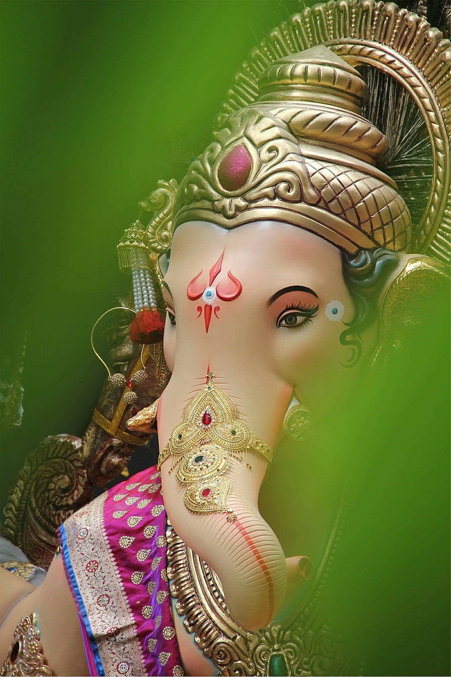 Close-up of Lord Ganesha Statue with Golden Crown and Jewelry HD phone wallpaper