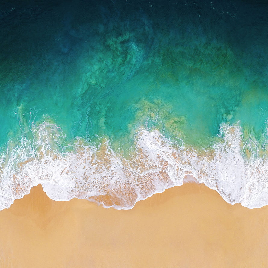 Aerial View of Turquoise Ocean Waves Breaking on Golden Sandy Beach HD phone wallpaper