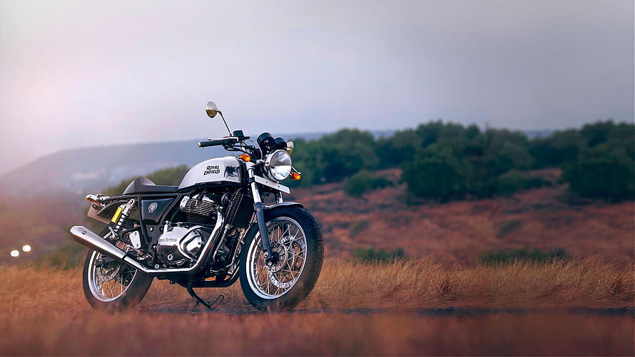 Royal Enfield Classic 350 Motorcycle in a Scenic Rural Landscape at Sunset HD wallpaper