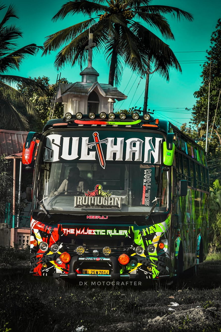 Sulthan Holidays Neeraj Bus with Vibrant Graphics and Tropical Palm Tree Backdrop HD phone wallpaper