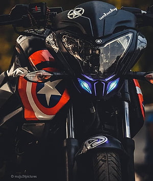 Custom motorcycle featuring Captain America shield decal and blue LED headlights HD phone wallpaper