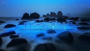 Lenovo Legion logo glowing in blue neon over a misty rocky coastline with long exposure water HD wallpaper