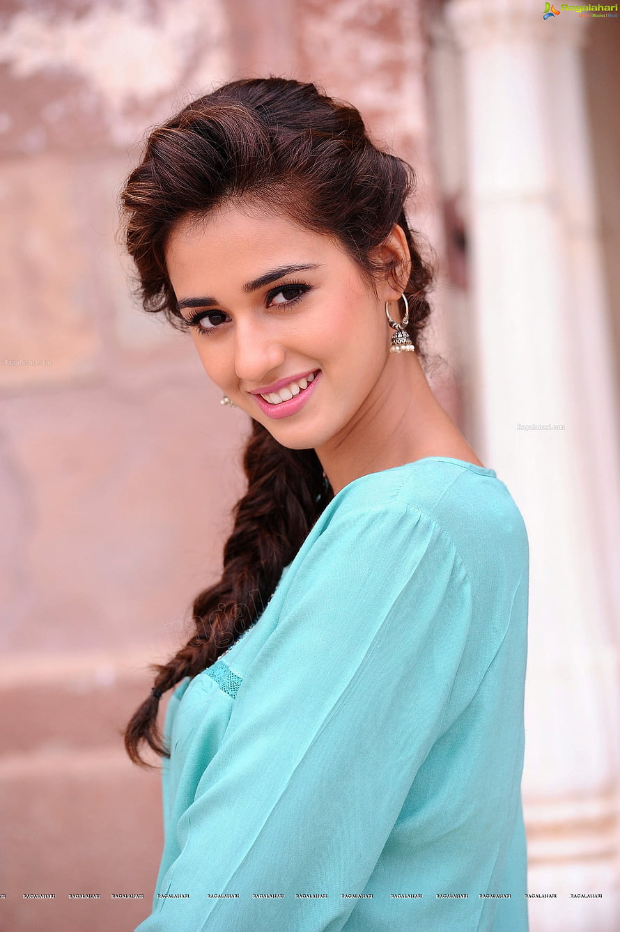 Disha Patani in a stylish turquoise top with a braided hairstyle and traditional earrings HD phone wallpaper