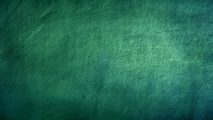 Textured Green Chalkboard Surface with Faint Scratches and Soft Lighting HD wallpaper