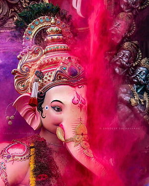 Vibrant Ganesha Portrait with Ornate Crown and Red Powder HD phone wallpaper
