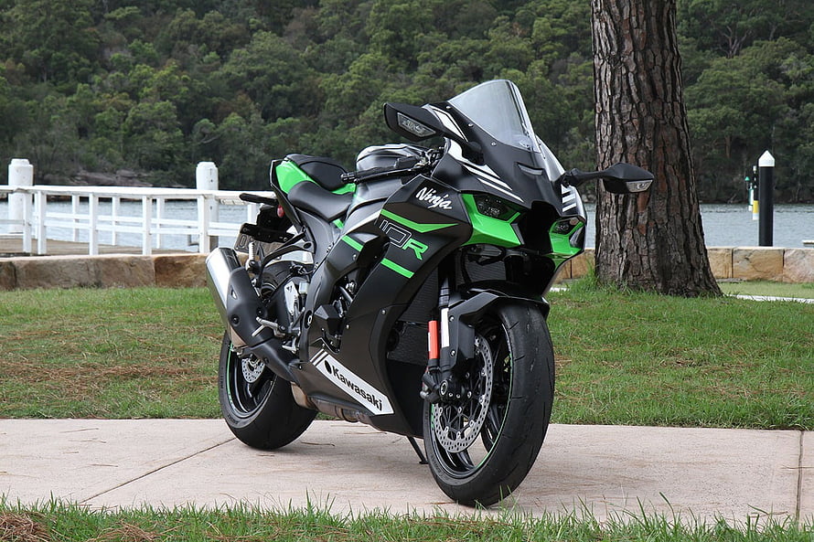 Kawasaki Ninja ZX-10R sportbike parked on a lakeside path with green and black livery HD wallpaper