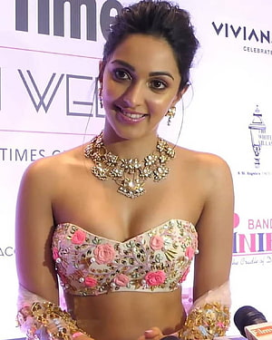 Kiara Advani in a floral embroidered lehenga with gold jewelry at a red carpet event HD phone wallpaper