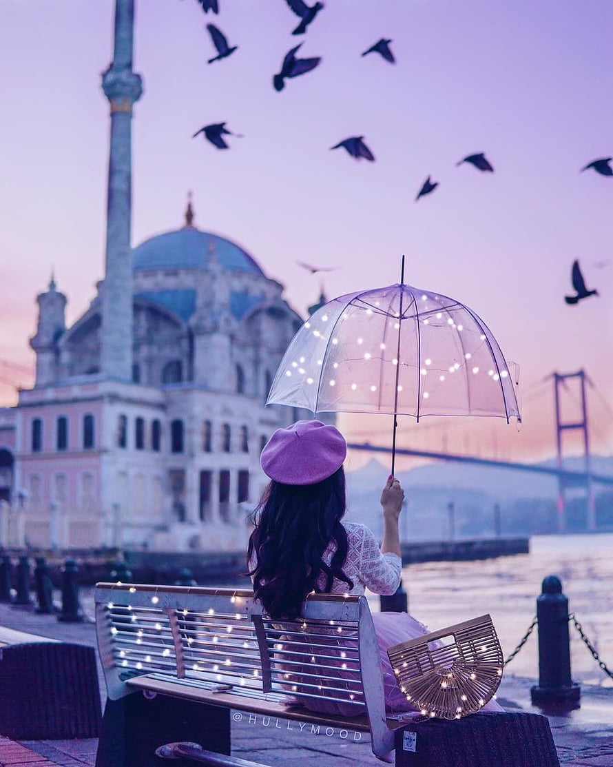 Girl with Light-Up Umbrella Sitting on Bench Facing Istanbul Mosque at Sunset HD phone wallpaper