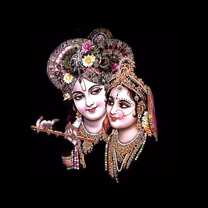 Lord Krishna and Radha in ornate traditional attire with a flute on a black background HD phone wallpaper