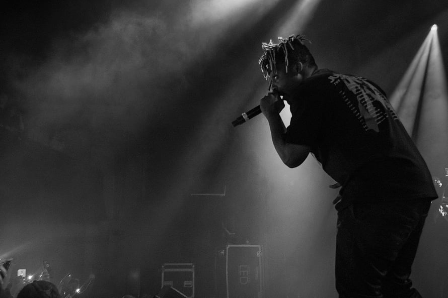 Juice WRLD performing live on stage in dramatic black and white concert lighting HD wallpaper