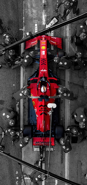 Overhead View of Ferrari Formula 1 Car During Pit Stop with Crew HD phone wallpaper