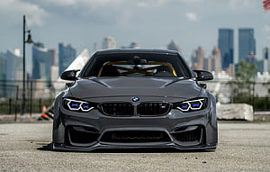 Front View of a Modified BMW M4 F82 with Widebody Kit and Blue LED Headlights HD wallpaper
