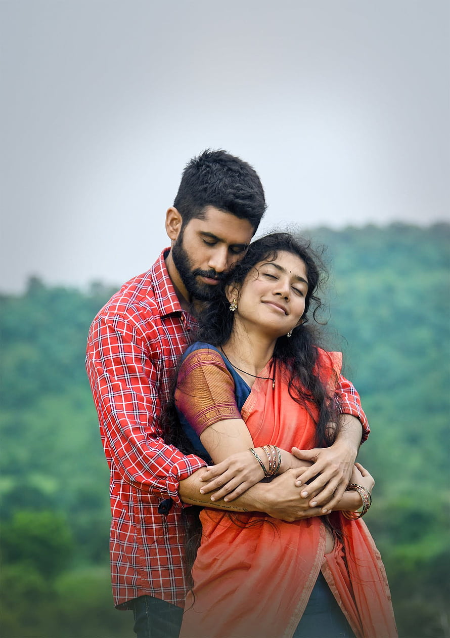 Romantic Indian couple embracing outdoors with lush green hills in the background HD phone wallpaper