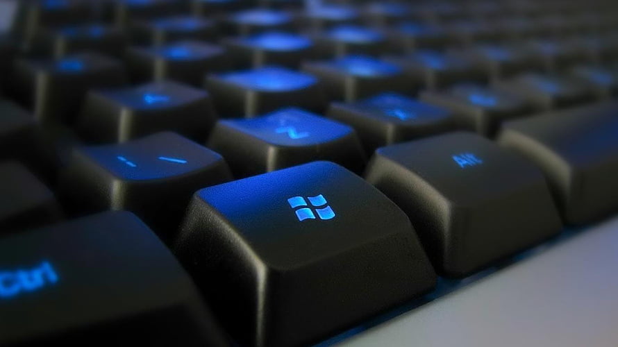 Close-Up of Black Keyboard with Blue Backlit Windows Key HD wallpaper