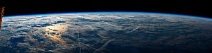 Panoramic View of Earth's Curvature from Space with Solar Panel HD wallpaper