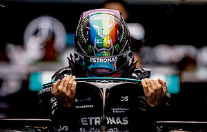 Lewis Hamilton in Mercedes Petronas Racing Suit and Rainbow Helmet HD wallpaper
