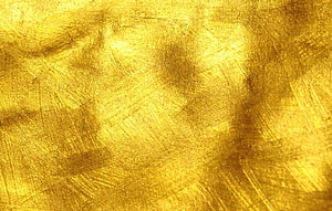 Shimmering Gold Leaf Texture with Brushed Metallic Surface and Warm Amber Tones HD wallpaper