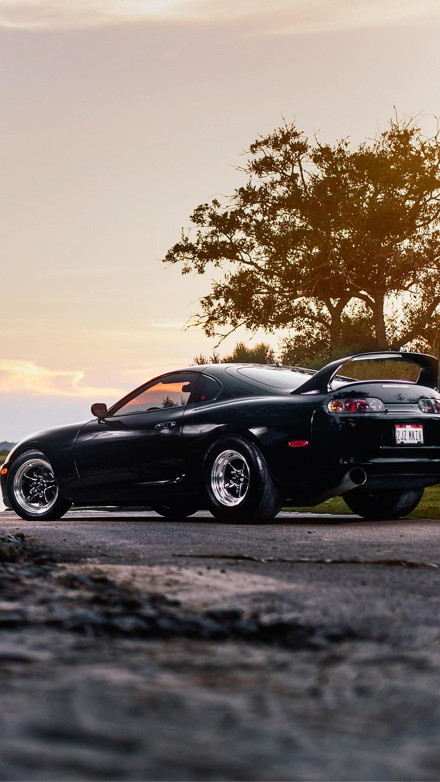Black Toyota Supra MK4 Coupe Parked at Sunset with Rear Spoiler and Chrome Wheels HD phone wallpaper