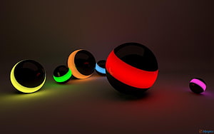 Glossy 3D Spheres with Neon Glowing Bands on Dark Background HD wallpaper