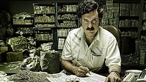 Pablo Escobar Counting Stacks of Cash in a Dark Warehouse HD wallpaper