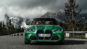 Green BMW M3 Competition Coupe Parked on Mountain Road with Snowy Peaks HD wallpaper