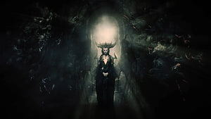 Lilith from Diablo IV Standing in a Dark Cavern with Ethereal Light and Horned Headdress HD wallpaper