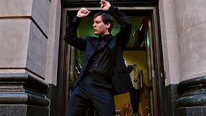 Eddie Murphy in black suit striking a pose in doorway from the movie Coming to America HD wallpaper