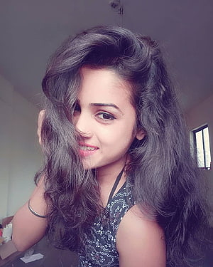 Portrait of a young woman with long wavy dark hair smiling and touching her face, 70 Cute Girl DP For Whatsapp, #cute girl dp HD phone wallpaper