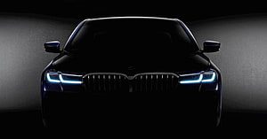 BMW 5 Series G30 LCI Front Facade With Illuminated Adaptive LED Headlights In Dark Studio Setting HD wallpaper