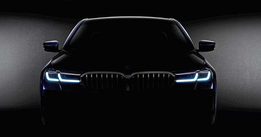 BMW 5 Series G30 LCI Front Facade With Illuminated Adaptive LED Headlights In Dark Studio Setting HD wallpaper