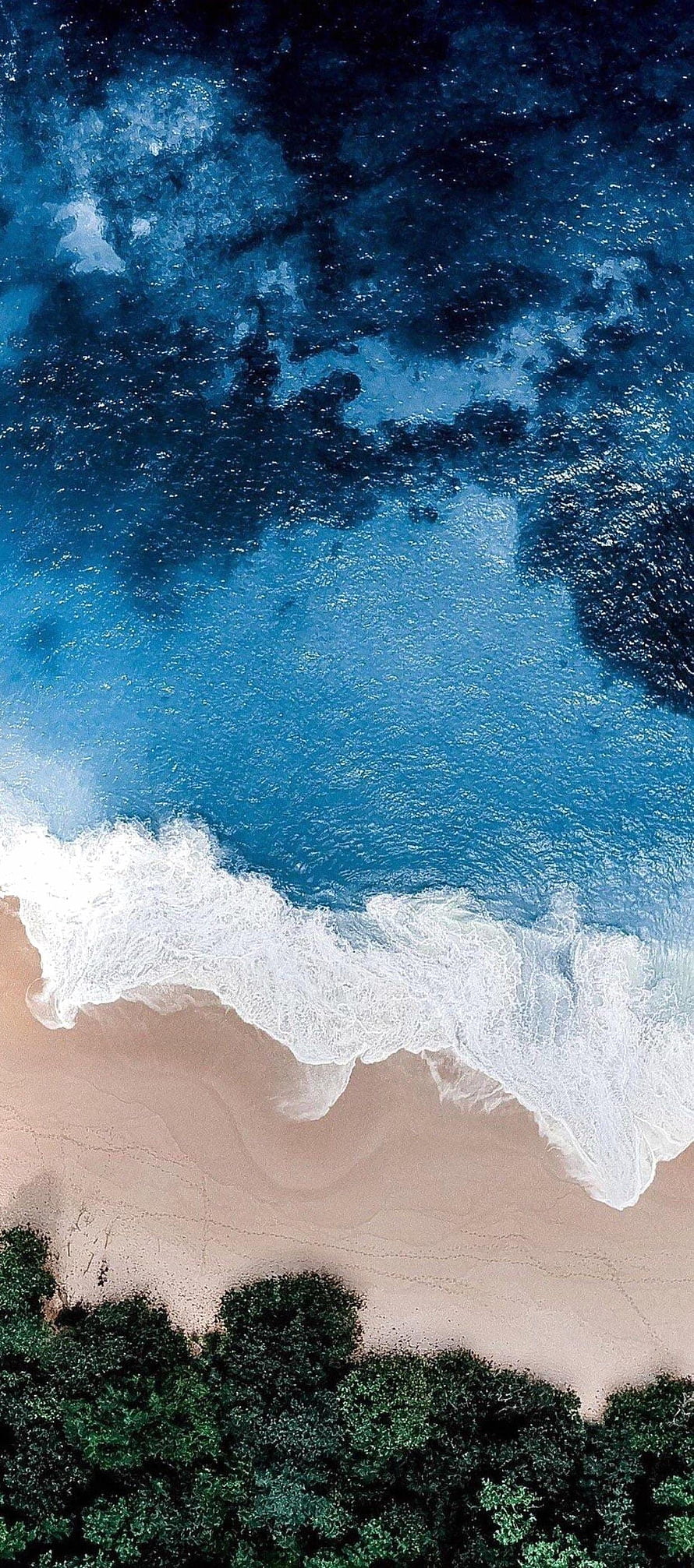 Aerial View of Turquoise Ocean Waves Crashing on Sandy Beach with Green Forest HD phone wallpaper