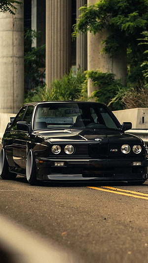 Black BMW E36 M3 Stance Style Car on Street with Concrete Pillars HD phone wallpaper