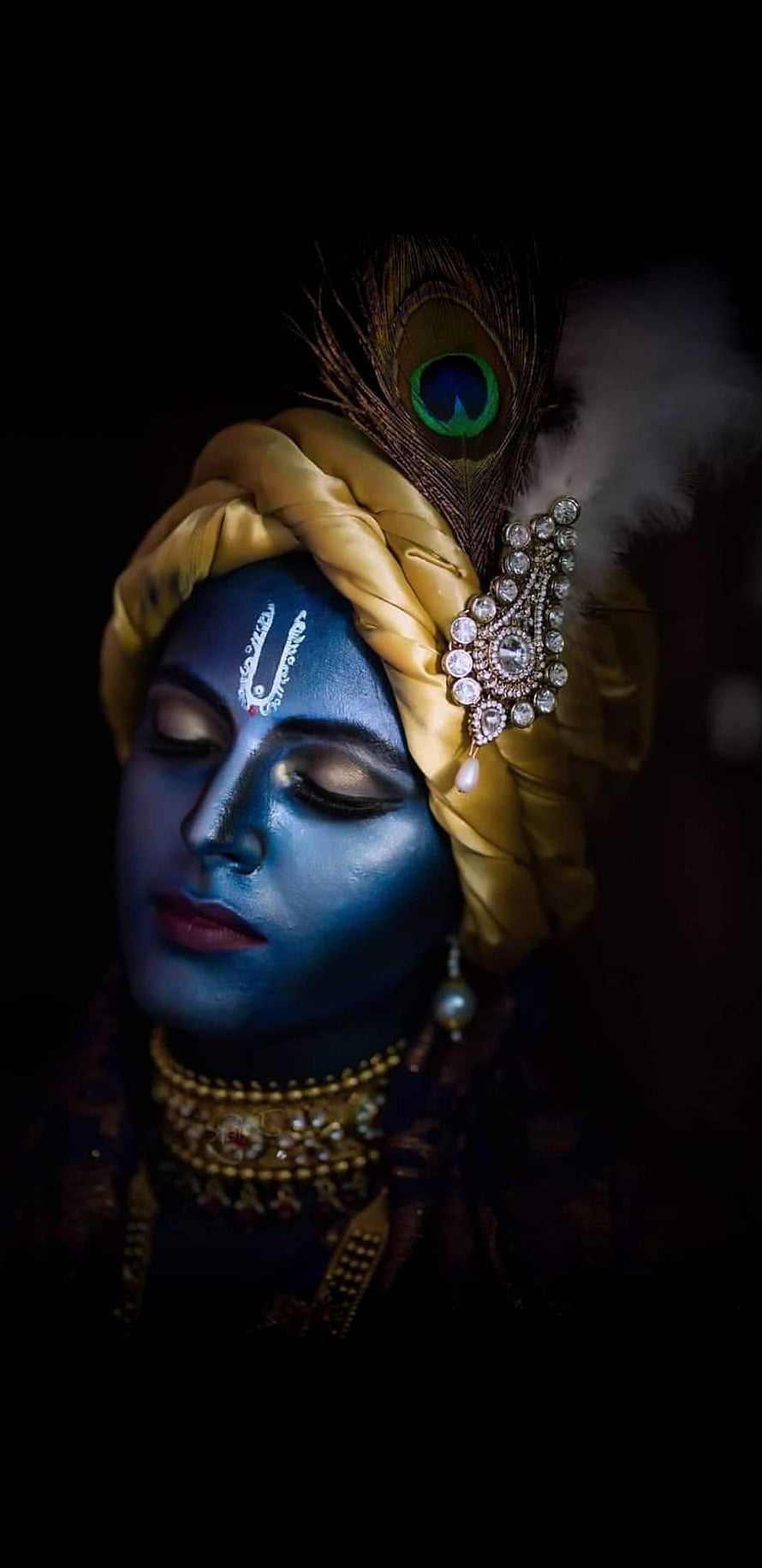 Serene Portrait of Lord Krishna with Blue Skin, Peacock Feather, and Golden Turban HD phone wallpaper