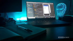 Dark Developer Workspace With Code Editor, Notebook, and Neon Iron Man Head Sculpture, Android Developer, app development HD wallpaper