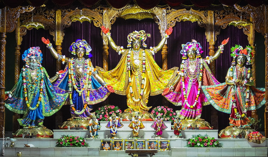 Vibrant idols of Lord Jagannath, Balabhadra, Subhadra, and Sudarshana Chakra in a temple HD wallpaper