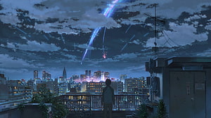 Anime boy watching colorful meteor shower over city skyline at night from rooftop HD wallpaper