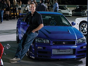Paul Walker Leaning Against a Blue Nissan Skyline GT-R at a Nighttime Car Meet HD wallpaper