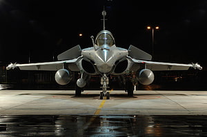 Indian Air Force Rafale Fighter Jet Parked on Wet Tarmac at Night HD wallpaper