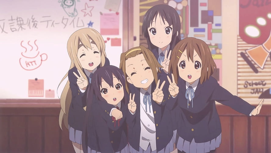 Five cheerful schoolgirls in dark blazers posing with peace signs in a cozy Japanese classroom HD wallpaper