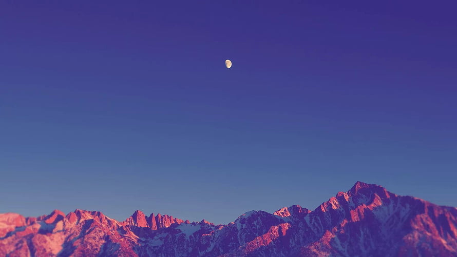 Pink Alpenglow Mountain Range Under Blue Sky With Crescent Moon HD wallpaper