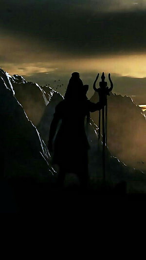 Silhouette of Lord Shiva Holding Trishul Against Mountain Sunset HD phone wallpaper