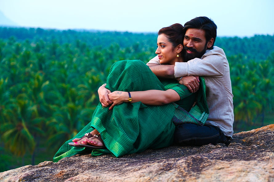 Dhanush and Trisha in romantic embrace on rocky hilltop overlooking lush green palm forest, Actor Dhanush And Trisha Stills From Kodi Tamil Movie, kodi movie HD wallpaper