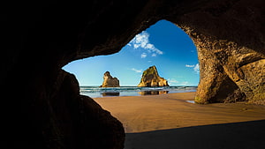 Sea Cave Viewpoint Framing Coastal Rock Formations and Sandy Beach HD wallpaper