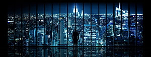 Silhouette of a Man Standing in a High-Rise Office Overlooking a Glowing City Skyline at Night, Dual Monitor HD wallpaper