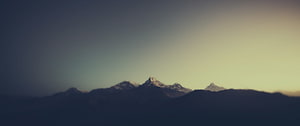 Majestic Snow-Capped Mountain Peaks at Dusk with Golden Sky HD wallpaper