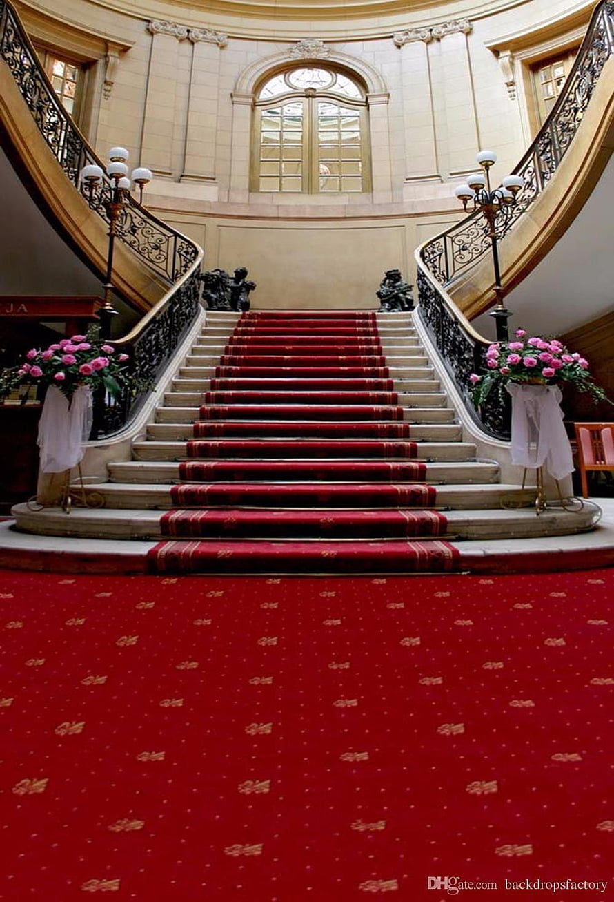 Grand Marble Staircase with Red Carpet and Pink Floral Arrangements in an Elegant Hall HD phone wallpaper
