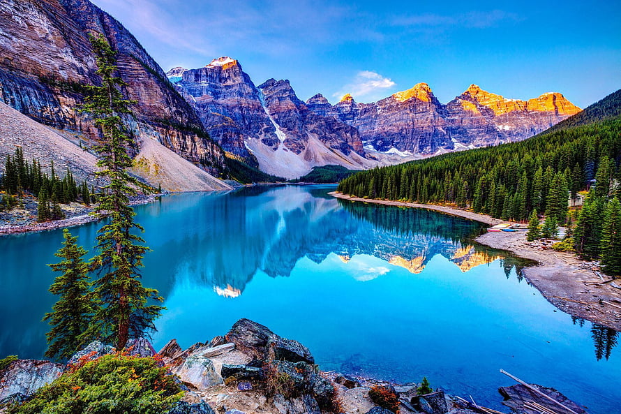 Maligne Lake Reflections of the Canadian Rockies with Golden Sunlit Peaks and Pine Forests HD wallpaper
